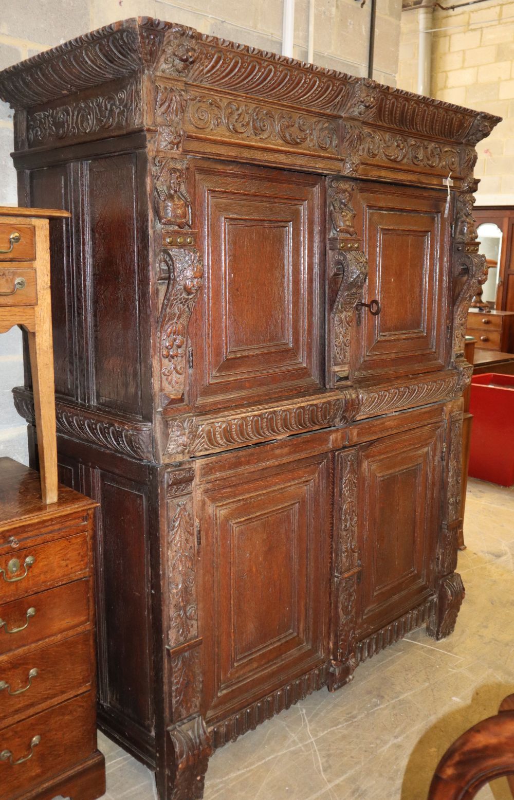 A 19th century Jacobean revival carved oak press cupboard, W.157cm, H.197cm